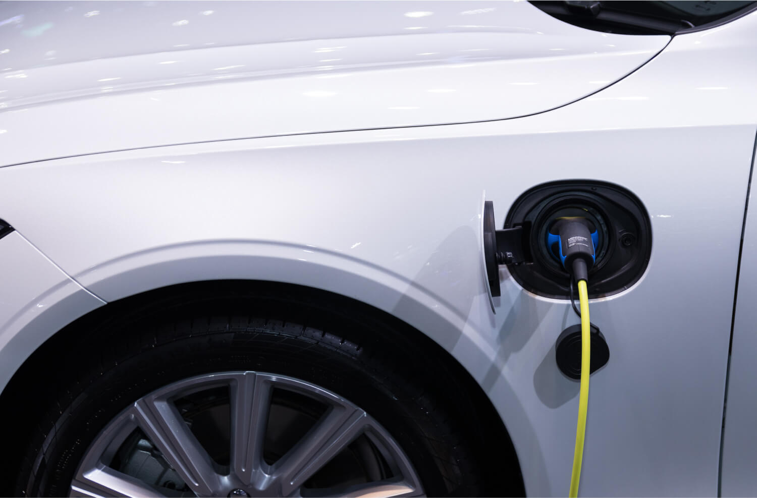 Recharge technician charging an electric vehicle at the roadside